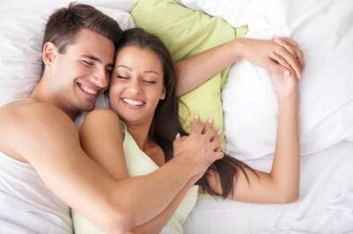 Happy man and girl in bed